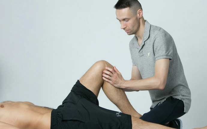 a man getting his leg examined by a doctor